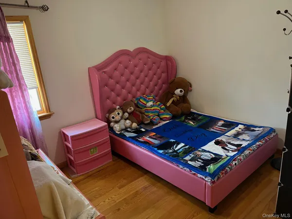 a wooden bench sitting in a room next to a window