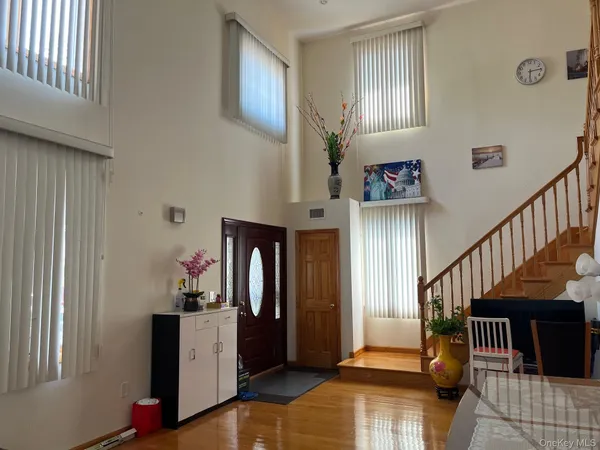 a view of entryway livingroom and hall with wooden floor