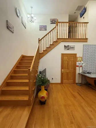 a view of entryway livingroom and hall with wooden floor