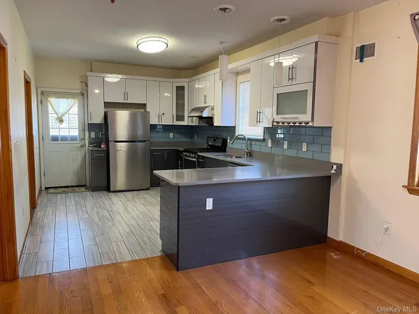 a kitchen with a refrigerator and a sink