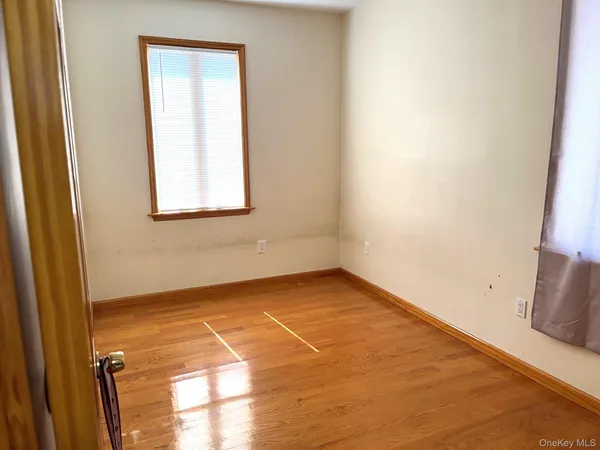 a view of a room with an empty space and a window