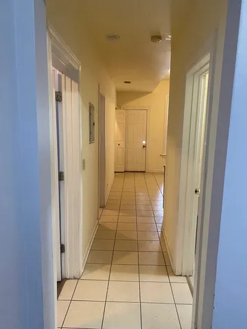 a bathroom with a granite countertop toilet a sink and a mirror