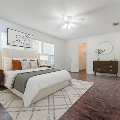 a spacious bedroom with a bed and window