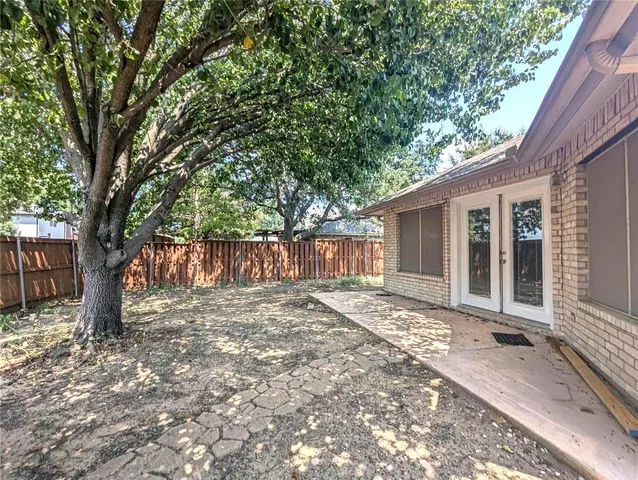 a view of a house with a tree in front