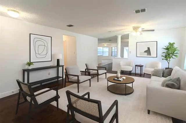 a living room with furniture a rug and a window