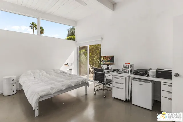 a bedroom with a bed and a desk