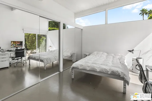 a bedroom with a bed and a desk