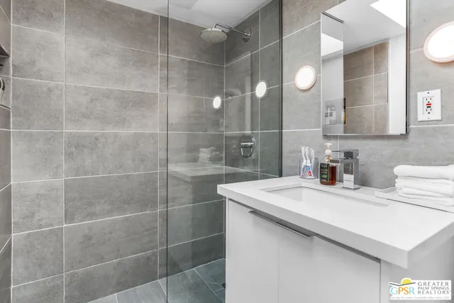 a patio with a table and chairs under an umbrella