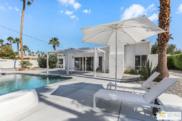a view of a swimming pool with a lounge chairs