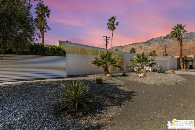 a dining room with furniture window and wooden floor