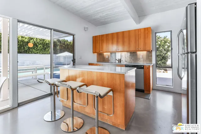 a kitchen with a table chairs and wooden floor