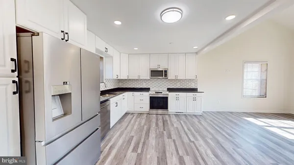 a bathroom with a granite countertop toilet and a shower
