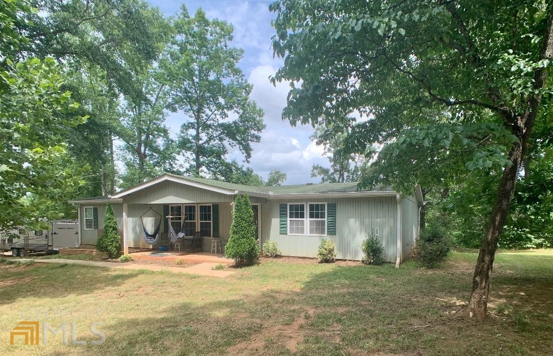 135 Peoples Road Jackson, GA 30233 - Photo 1 of 1 a front view of a house with a garden
