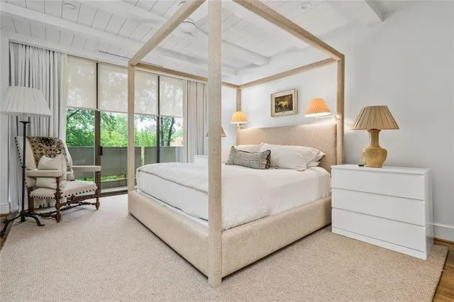 a bedroom with a bed and a lamp