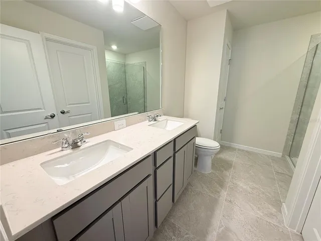 a bathroom with a sink a toilet a mirror and vanity