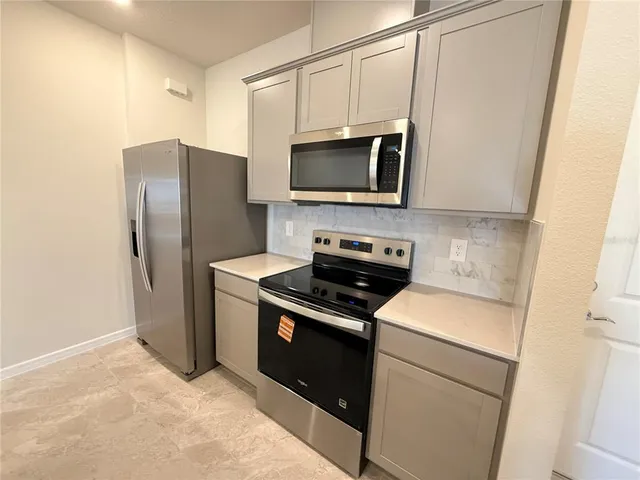 a kitchen with a stove microwave and refrigerator