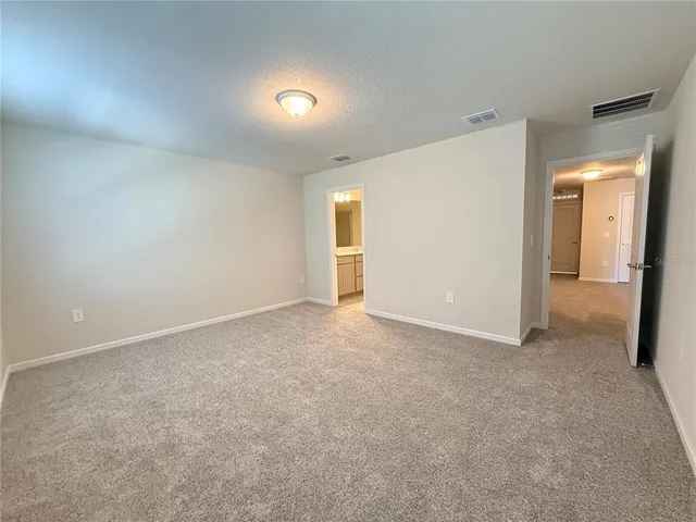 an empty room with closet and mirror