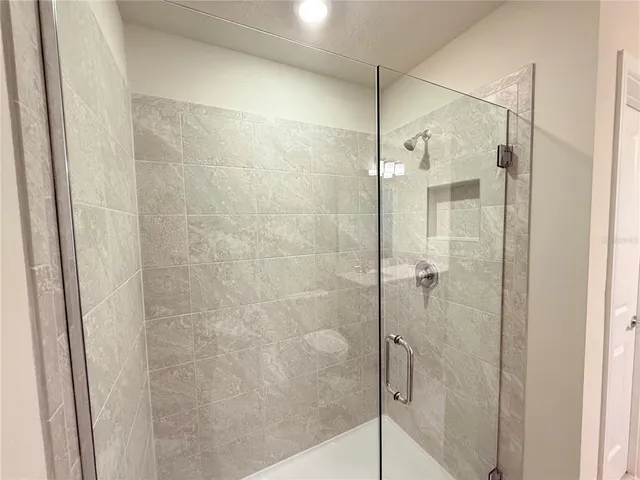 a bathroom with a glass shower door