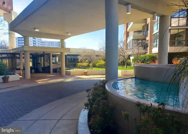 a kitchen with granite countertop a refrigerator and a stove top oven