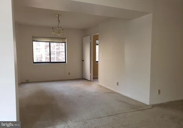 a view of an empty room and closet area