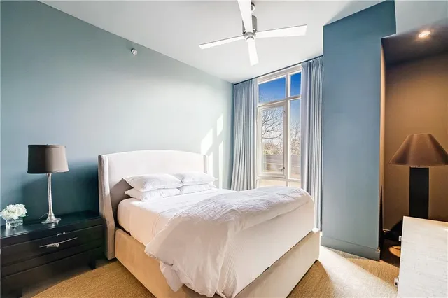 a bedroom with a bed and a night stand