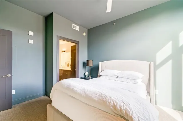 a bedroom with a bed and a mirror