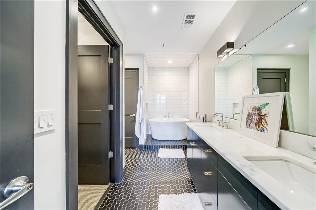 905 Juniper Street Northeast, Unit 405 Atlanta, GA 30309 - Photo 20 of 34 a spacious bathroom with a tub shower and sink