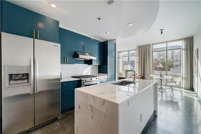 a kitchen with a refrigerator a stove a sink and a microwave