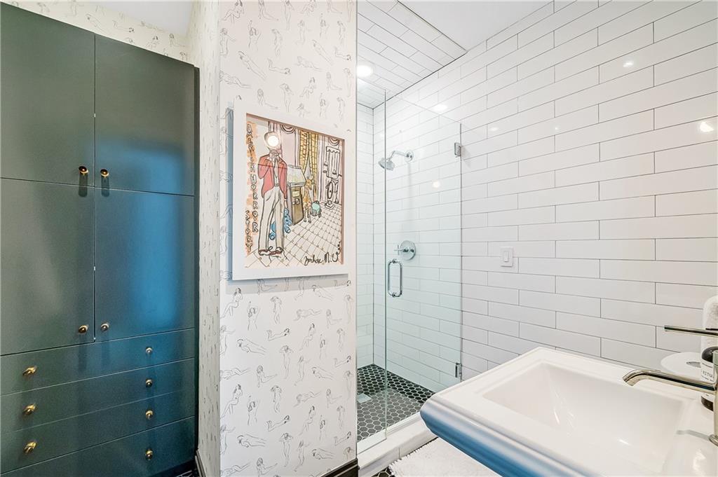 905 Juniper Street Northeast, Unit 405 Atlanta, GA 30309 - Photo 23 of 34 a bathroom with a sink and shower