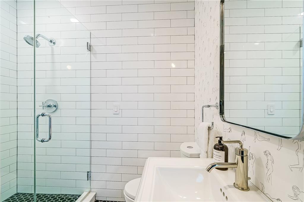 905 Juniper Street Northeast, Unit 405 Atlanta, GA 30309 - Photo 24 of 34 a bathroom with a sink a toilet and shower