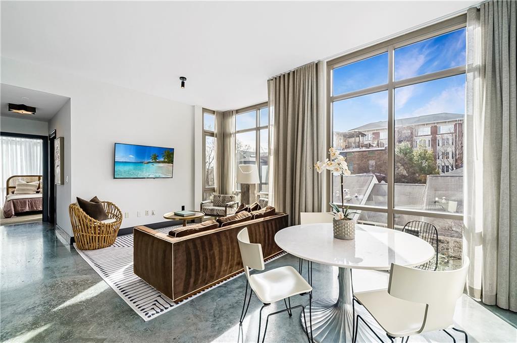 905 Juniper Street Northeast, Unit 405 Atlanta, GA 30309 - Photo 4 of 34 a table and chairs in a room
