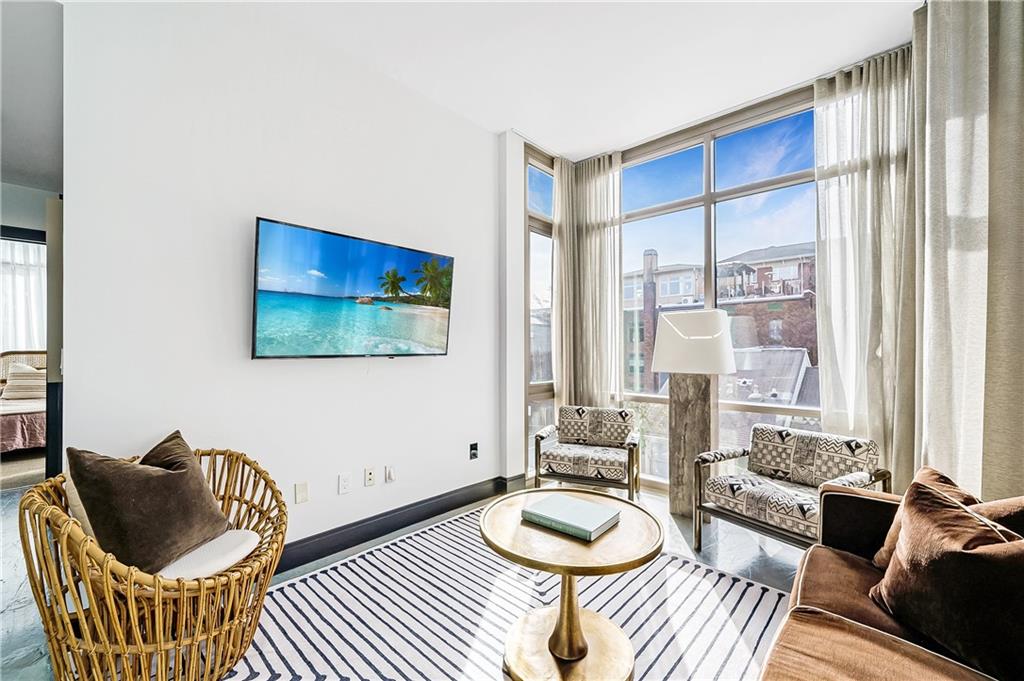 905 Juniper Street Northeast, Unit 405 Atlanta, GA 30309 - Photo 7 of 34 a living room with furniture and a window