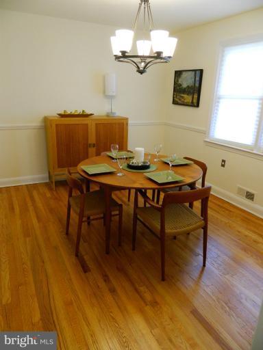 729 Charing Cross Road Baltimore, MD 21229 - Photo 13 of 26 a view of a dining room with furniture wooden floor and chandelier