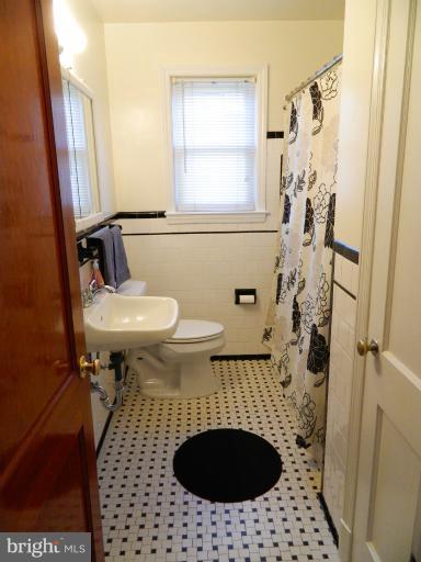 729 Charing Cross Road Baltimore, MD 21229 - Photo 14 of 26 a bathroom with a sink toilet and shower