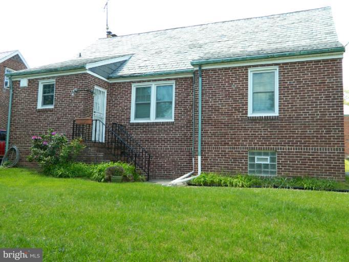 729 Charing Cross Road Baltimore, MD 21229 - Photo 22 of 26 a brick house with a yard