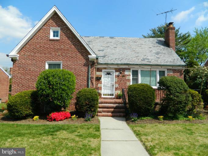 729 Charing Cross Road Baltimore, MD 21229 - Photo 26 of 26 a front view of a house with a yard and potted plants