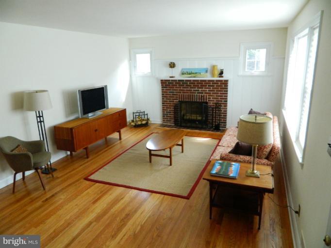 729 Charing Cross Road Baltimore, MD 21229 - Photo 4 of 26 a living room with furniture and a fireplace
