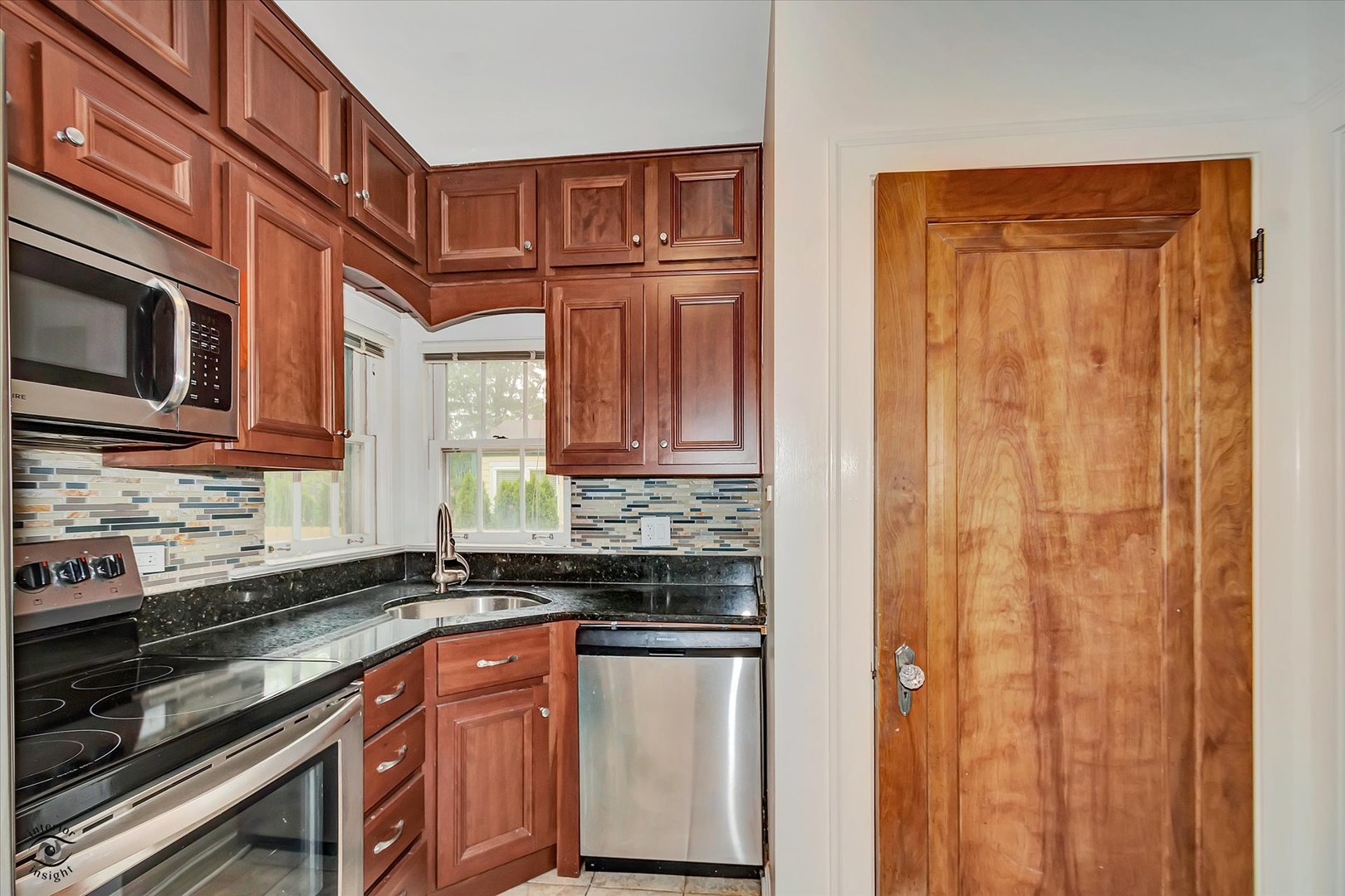 920 Juniper Road Glenview, IL 60025 - Photo 6 of 25 a kitchen with stainless steel appliances granite countertop a stove and a microwave