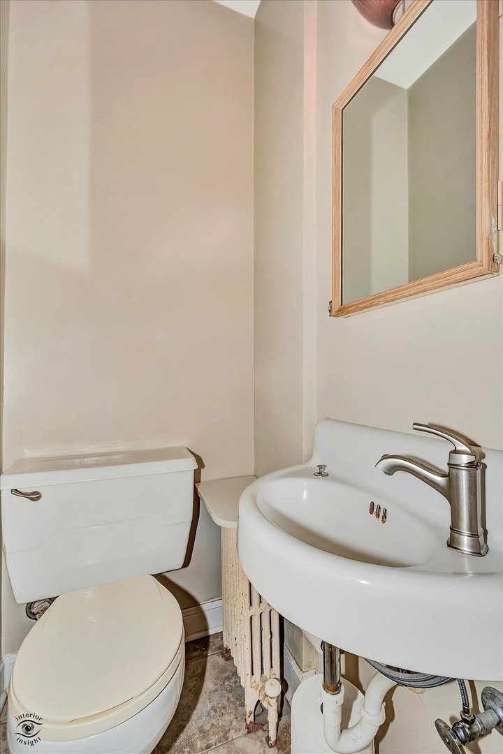 920 Juniper Road Glenview, IL 60025 - Photo 7 of 25 a white toilet sitting next to a bathroom sink