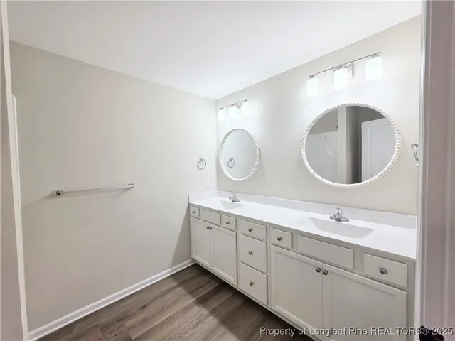 a bathroom with 2 sink and a mirror