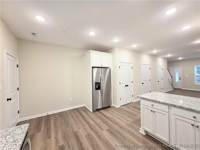 a view of a kitchen cabinets a sink and a refrigerator