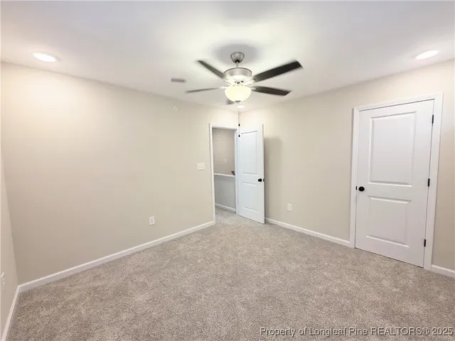 an empty room with fan and a ceiling fan