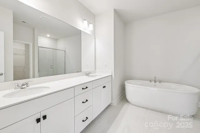 a white bath tub sitting next to a shower