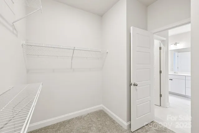 an empty room with ceiling fan and window
