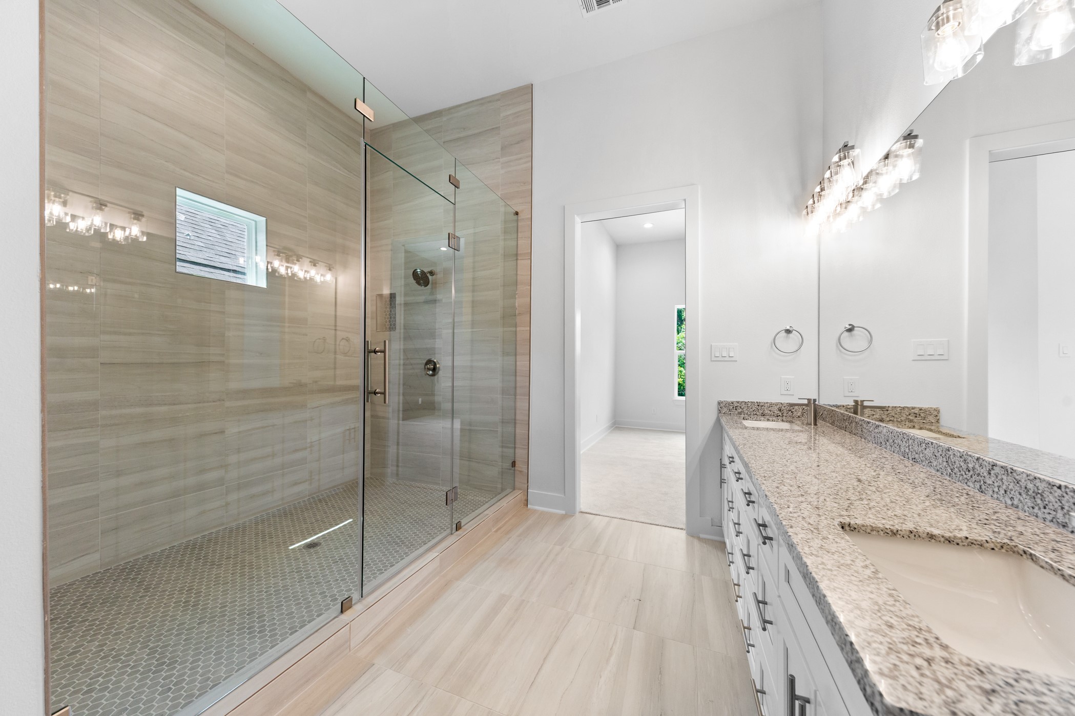 4710 Gunter Street Houston, TX 77020 - Photo 18 of 32 a spacious bathroom with a granite countertop sink a mirror a shower and a bathtub