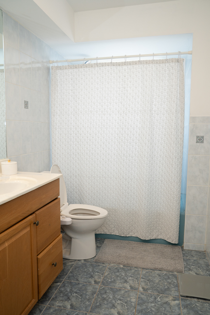 214 South Mt Prospect Road Mount Prospect, IL 60056 - Photo 20 of 25 a bathroom with a toilet a sink and a shower