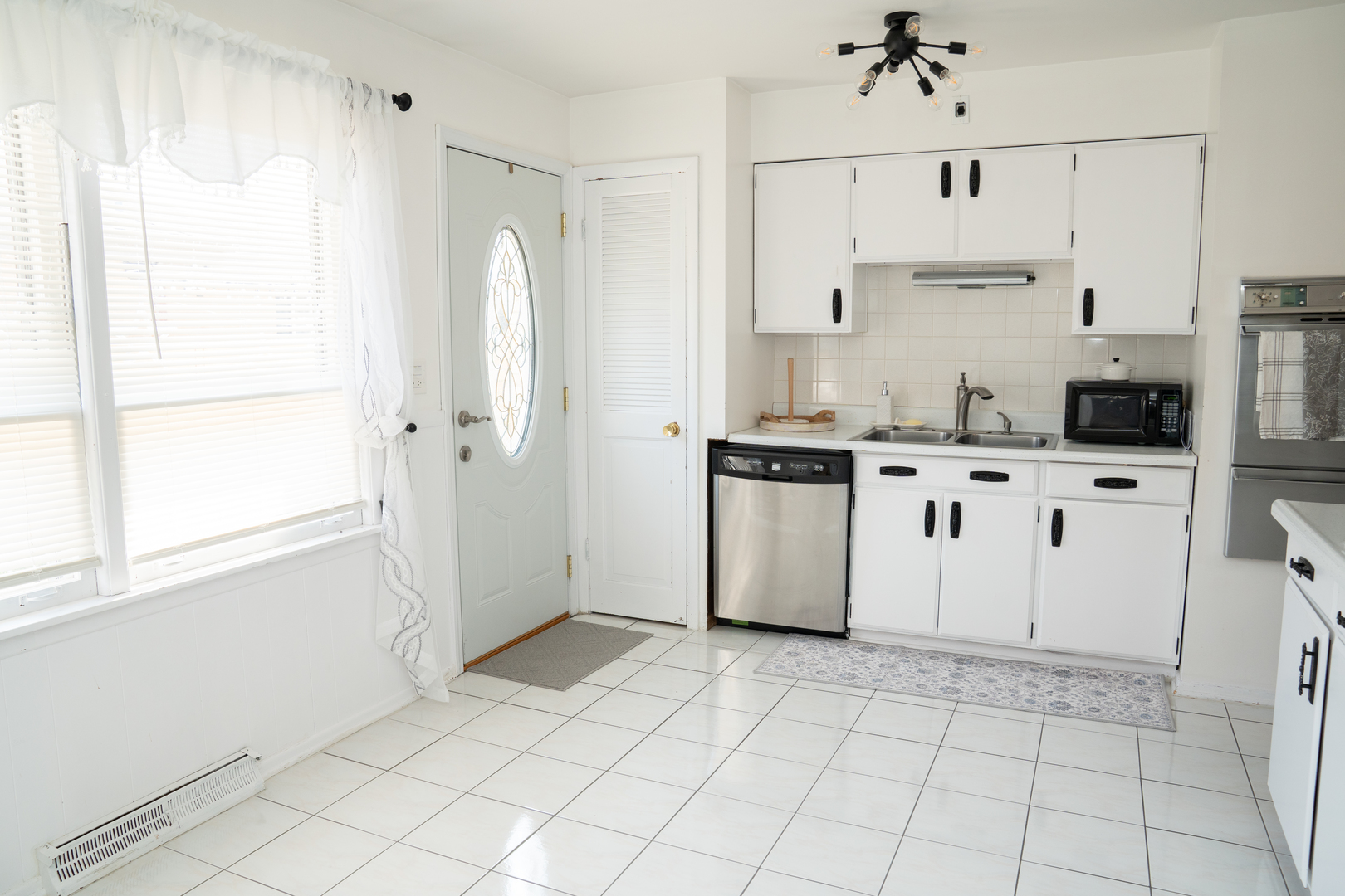 214 South Mt Prospect Road Mount Prospect, IL 60056 - Photo 6 of 25 a kitchen with stainless steel appliances cabinets a sink and a window