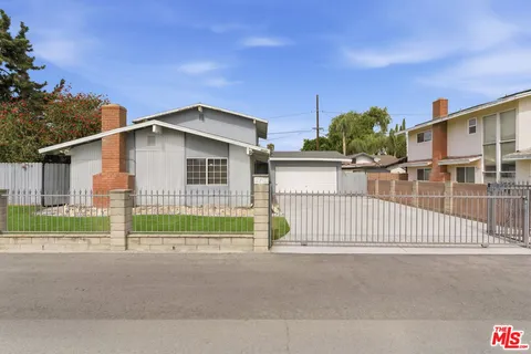 a view of a house with a small yard and plants