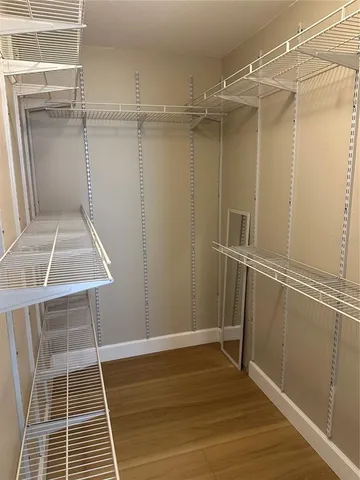 a view of a room with wooden floor and white walls