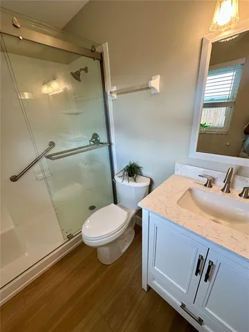 a bathroom with a sink toilet and shower